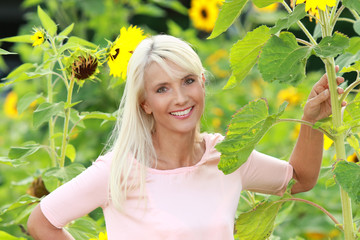 Mature woman with sunflowers