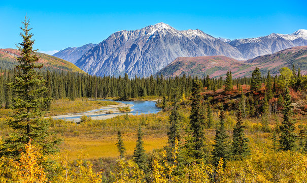 Scenic fall landscape with river and snow-capped mountains in Denali National Park, Alaska 