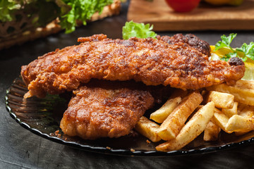 Fried fish in crispy batter with chips