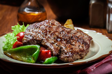 Portions of grilled beef steak with grilled potatoes and paprika