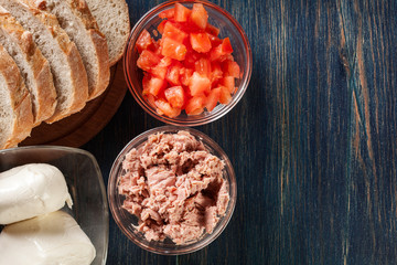 Ingredients ready for preparing bruschetta with tuna, mozzarella