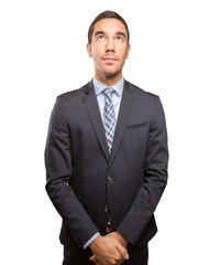 Satisfied young businessman looking up