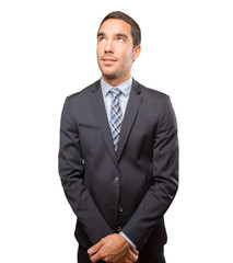 Satisfied young businessman looking up