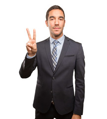 Happy young businessman doing a victory gesture