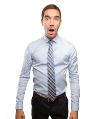 Surprised young businessman posing