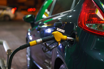 Fototapeta premium Car refueling on a petrol station in winter at night