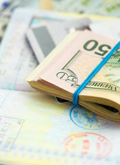 American money and credit cards lie on the top of the opened pas