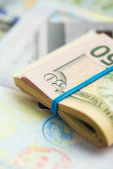 American money and credit cards lie on the top of the opened pas