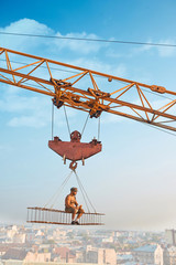 Man resting on construction on high and eating.