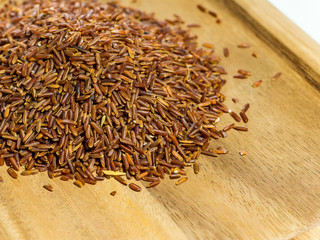 Red brown rice texture on the wooden dish with space, space for