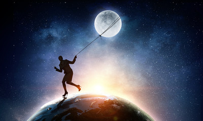 Fototapeta na wymiar Woman catching moon . Mixed media