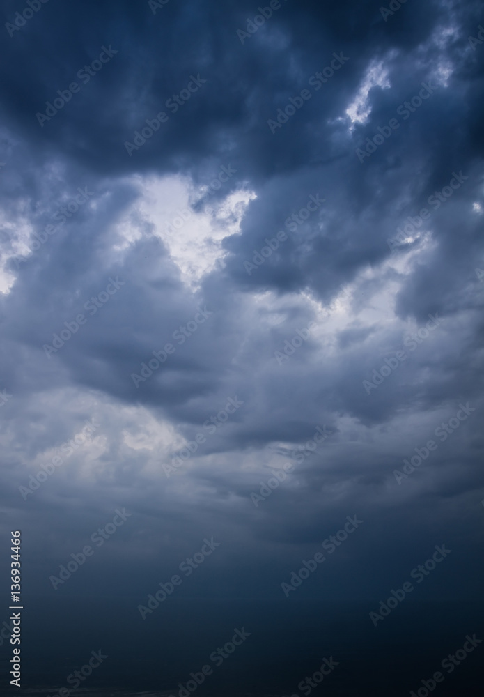 Wall mural dark stormy sky over sea