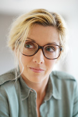 Portrait of blond woman with eyeglasses on