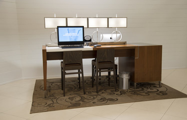 Workstation for hotel guests with comfortable seating a a desktop computer