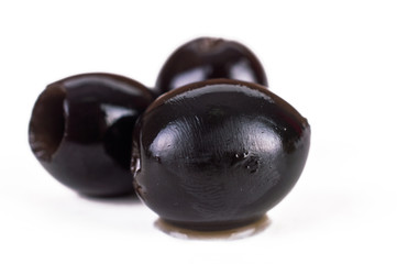 three olives from different sides on a white background
