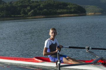 Child in the course of rowing on single