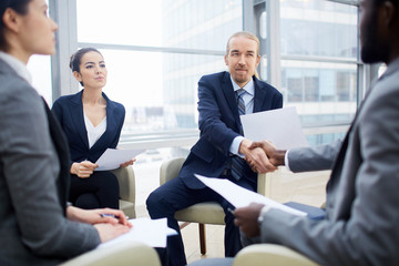 Businessmen handshaking after discussion of working terms