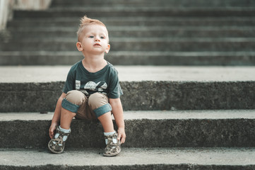 Fototapeta premium Little baby boy in fashionable clothing have fun outdoors
