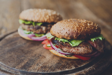 Classic american burgers, fast food on wood background