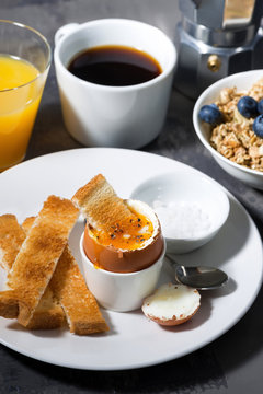 boiled egg, toasts and coffee for breakfast, vertical