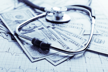 Dollars with stethoscope on them. Costs for the medical insuranc