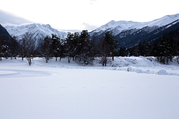Fototapeta na wymiar Winter landscape of snowy mountains on a clear day.