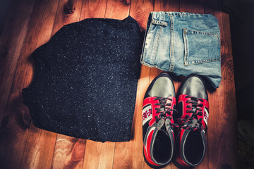 men's clothing, red sneakers on a wooden background,