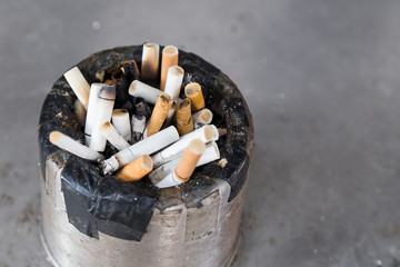 Dirty cigarette butts in ash tray