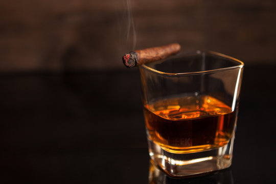 Smoking cigar and glass of whiskey