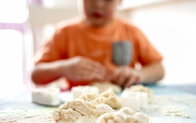 Dough. Kid enjoying making it.