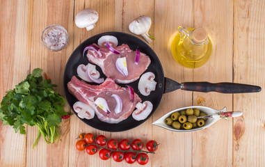 meat on the old pan with ingredients