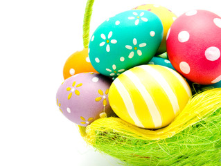 Perfect colorful handmade easter eggs in the basket isolated