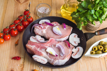 meat on the old pan with ingredients