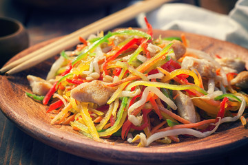 Stir fry chicken meat with vegetables and sprouts 