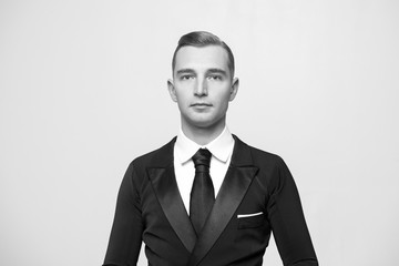 Confident attractive young man in tuxedo