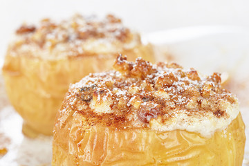 Apples baked with cottage cheese and raisins, decorated with nuts, cinnamon and powdered sugar