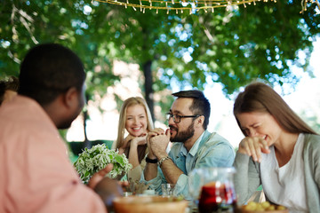 Happy young friends talking at leisure