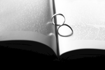 ring casting a heart-shaped shadow on the book page