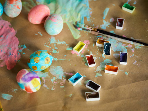 Creative Easter background with watercolors and painted eggs