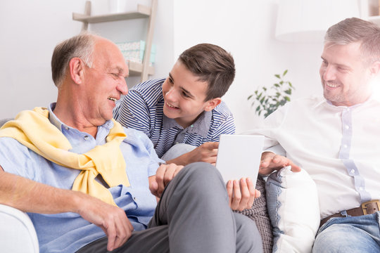 Grandfather making conversation with family