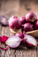 Onion. Red onions on very old oak wood board. Selective focus.