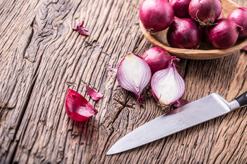 Onion. Red onions on very old oak wood board. Selective focus.