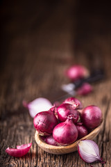 Onion. Red onions on very old oak wood board. Selective focus.