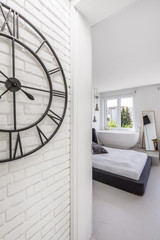 White brick bedroom with bathtub