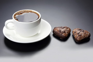 white cup of black coffee with biscuits heart