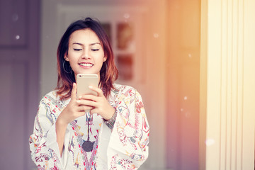 Photos of Asian woman looking at the phone and a smiley face rel