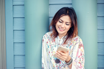 Photos of Asian woman looking at the phone and a smiley face rel