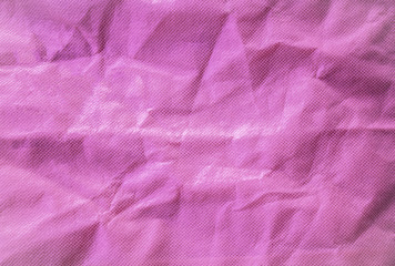 Fototapeta na wymiar Closeup empty pink crumled fabric wrinkles background