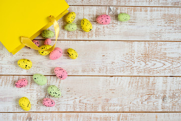 Easter eggs over white wooden vintage table - top view, copy space