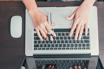 The images of Asian women are using a notebook,Focus on hands